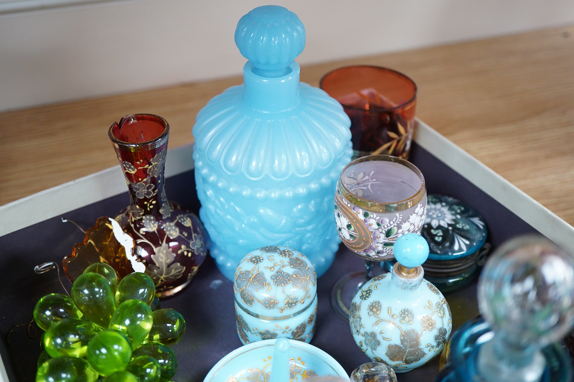 A collection of 19th century and later glassware to include gilt scent bottles, fruit ornaments and beakers, largest 14cm high
